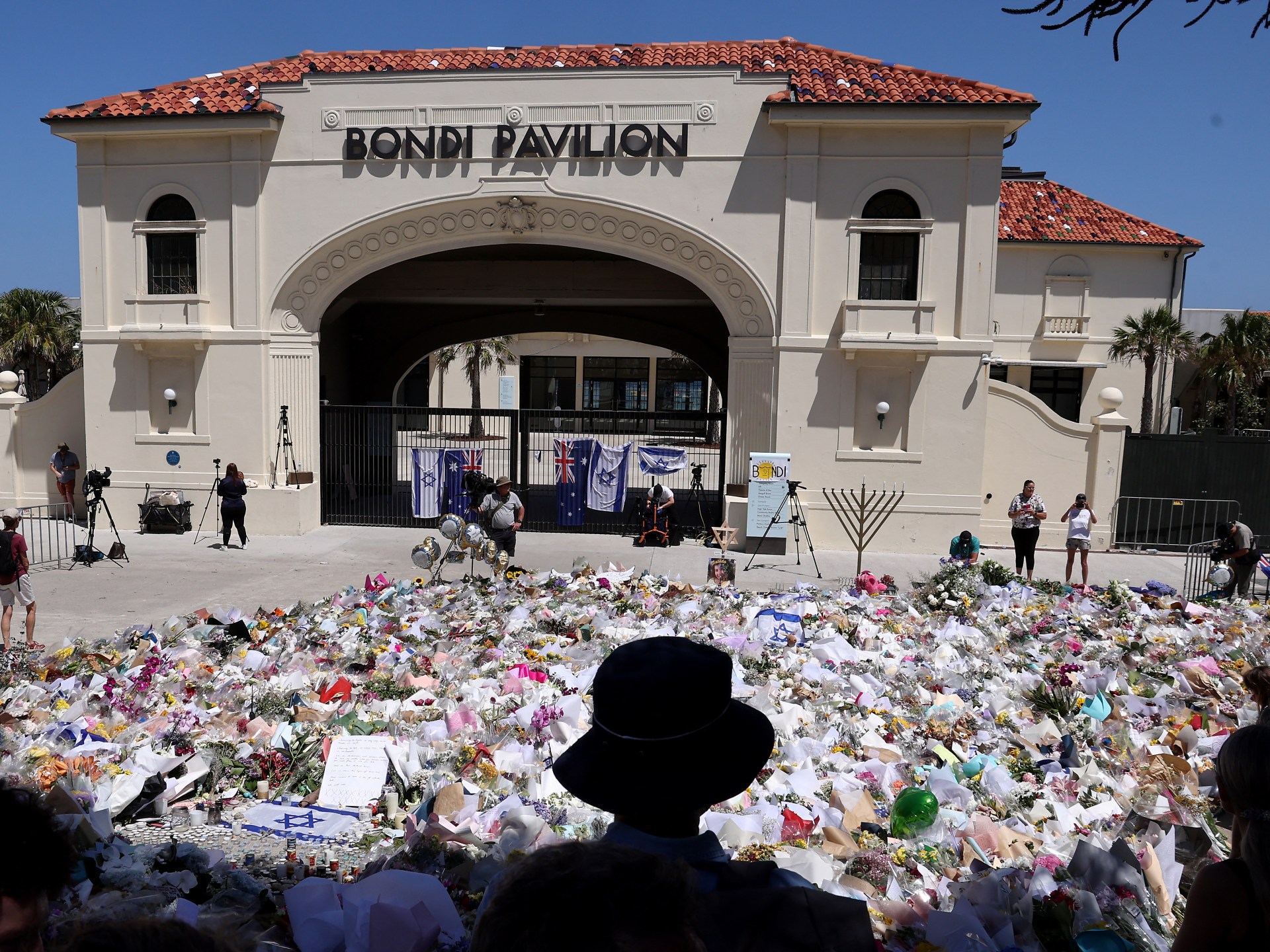 Australian police charge alleged Bondi Beach gunman as first funerals held 