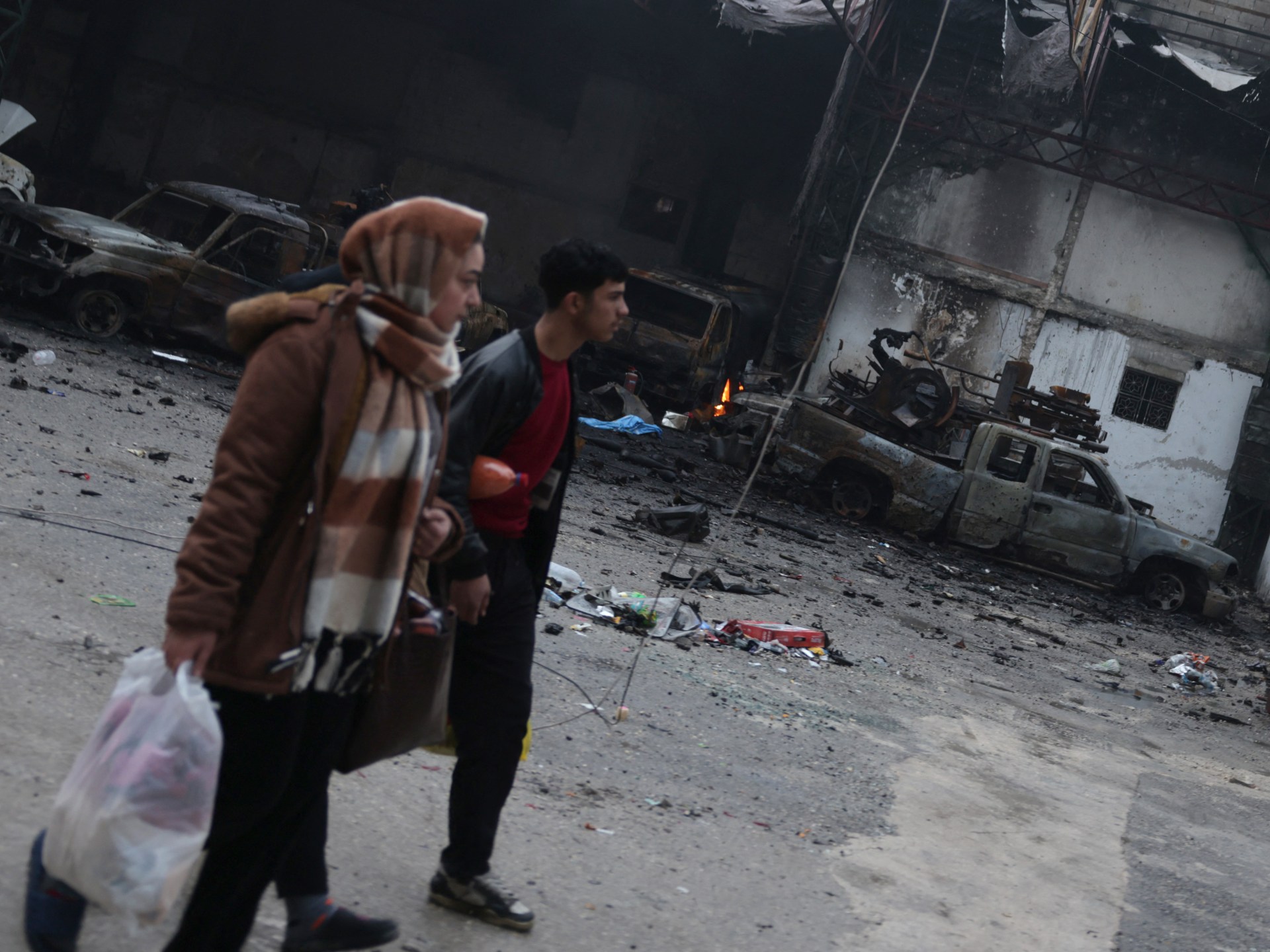 Photos: Syrians in Kurdish area of Aleppo pick up pieces after clashes 